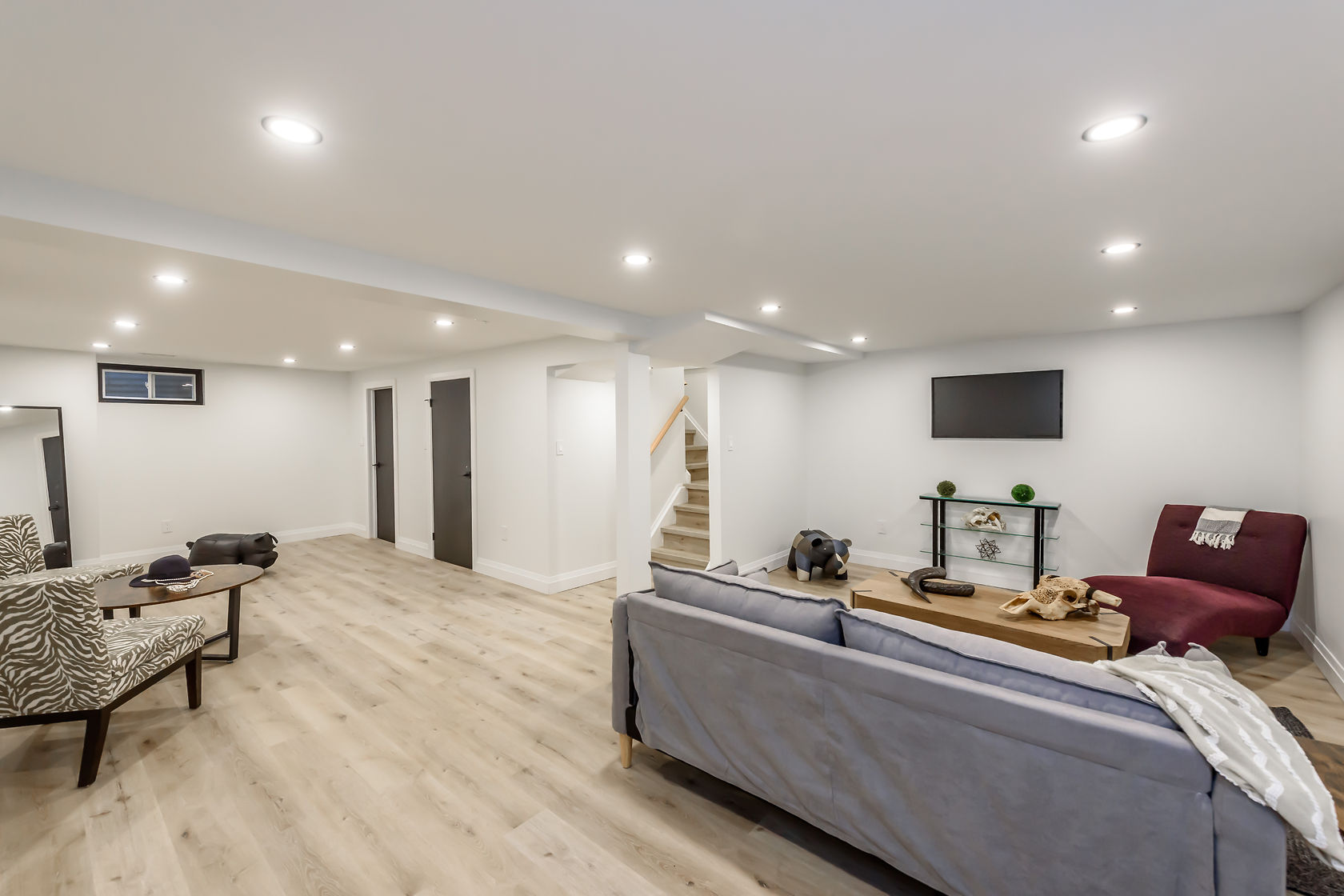 Bright finished basement with excellent staging and wide-angle composition — premium portfolio shot showing complete transformation — Gateshead, Hamilton | MTC Renovations